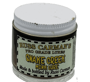 Jar of Carman's Pro Grade Snake Creek Mink Lure with a white lid and green label for attracting minks.