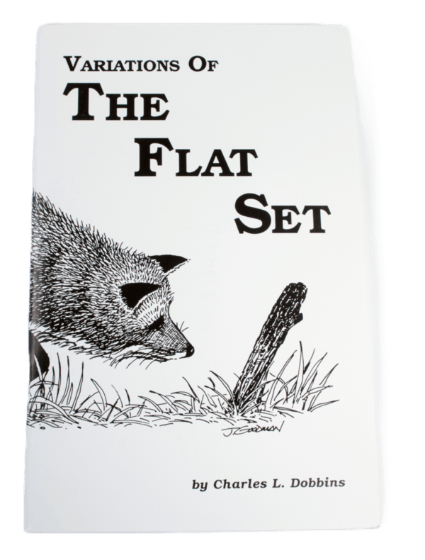 Book cover titled "Charles Dobbins - Variations of the Flat Set," with a fox near a stick in grass; ideal for trappers.