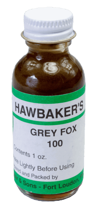 A small "Hawbaker's Grey Fox 100 Lure" with a white lid, renowned for trapping, marked to shake before use.