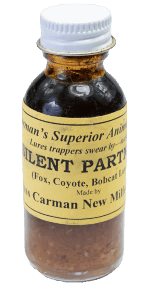Small glass bottle labeled "Carman's Silent Partner Lure," used for trapping fox, coyote, and bobcat.