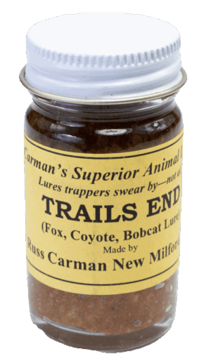 A small jar of Carman's Trails End Lure for trapping foxes, coyotes, and bobcats with a yellow label and silver lid.