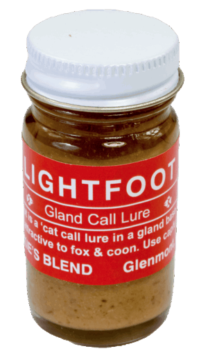 The small glass jar with a red label, "Blackie's Lightfoot Lure," attracts foxes and raccoons as a bobcat gland lure.