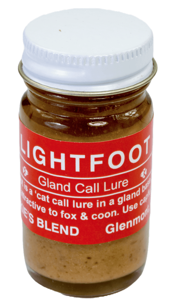 The small glass jar with a red label, "Blackie's Lightfoot Lure," attracts foxes and raccoons as a bobcat gland lure.
