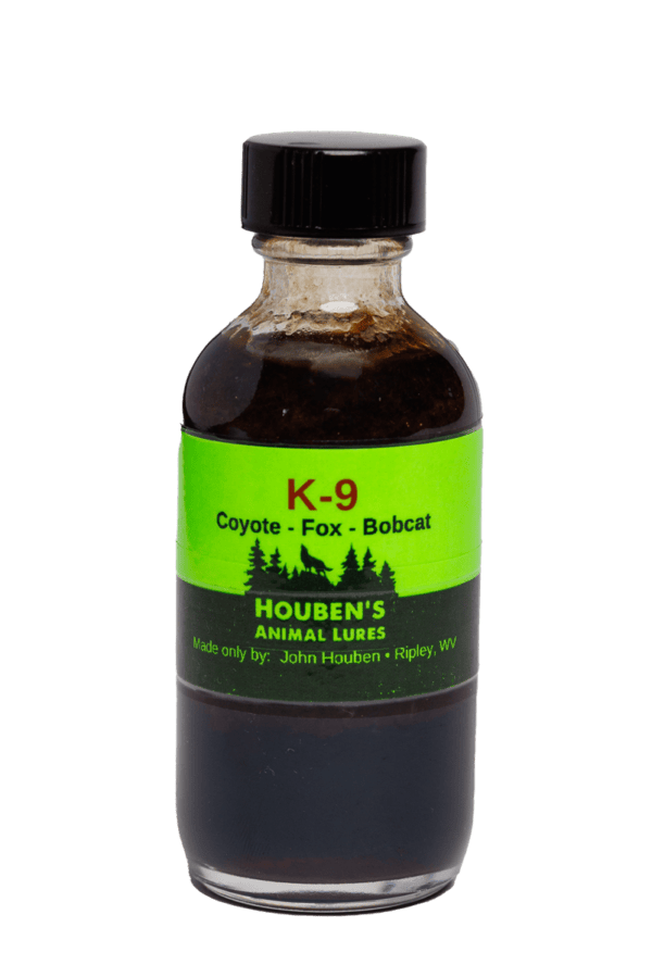 A small bottle labeled "Houben's K-9 Interceptor" for coyote, fox, and bobcat lures by Houben's Animal Lures, Ripley, WV.