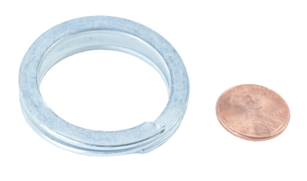 A Quick Connect Ring and a penny rest side by side against a plain white background.