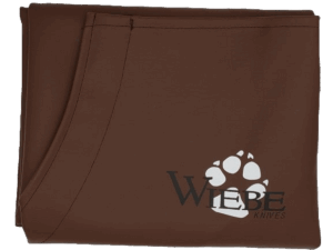 Brown "Wiebe" fabric with a white bear paw print logo, from the Heavy Duty Wiebe Brown Skinning Apron.