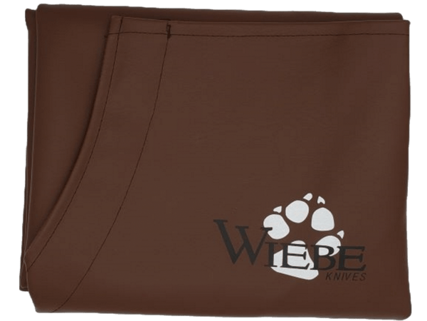 Brown "Wiebe" fabric with a white bear paw print logo, from the Heavy Duty Wiebe Brown Skinning Apron.