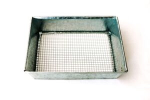 Metal Dirt Sifter with a rectangular wire mesh bottom on a white background.