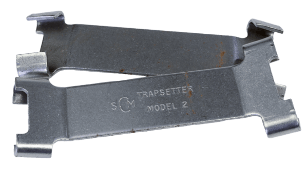 Two gray metal Coil Spring Setters, slightly rusted and overlapping on white, labeled "SCM TRAPSETTER MODEL 2.