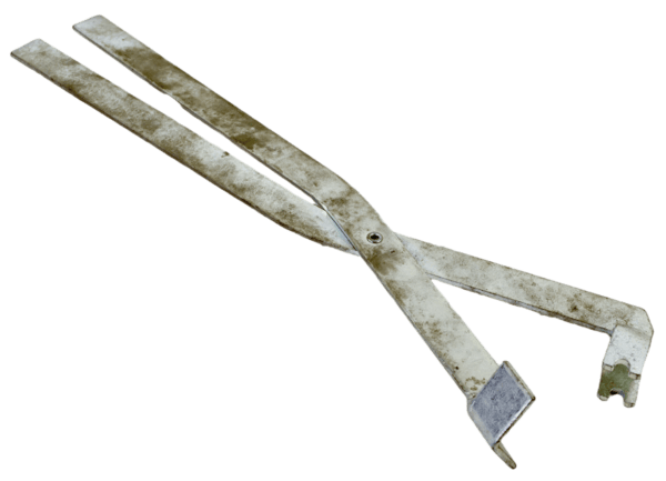 Trap Tweezers, resembling large rusted pincers with flat ends, isolated on a white background.